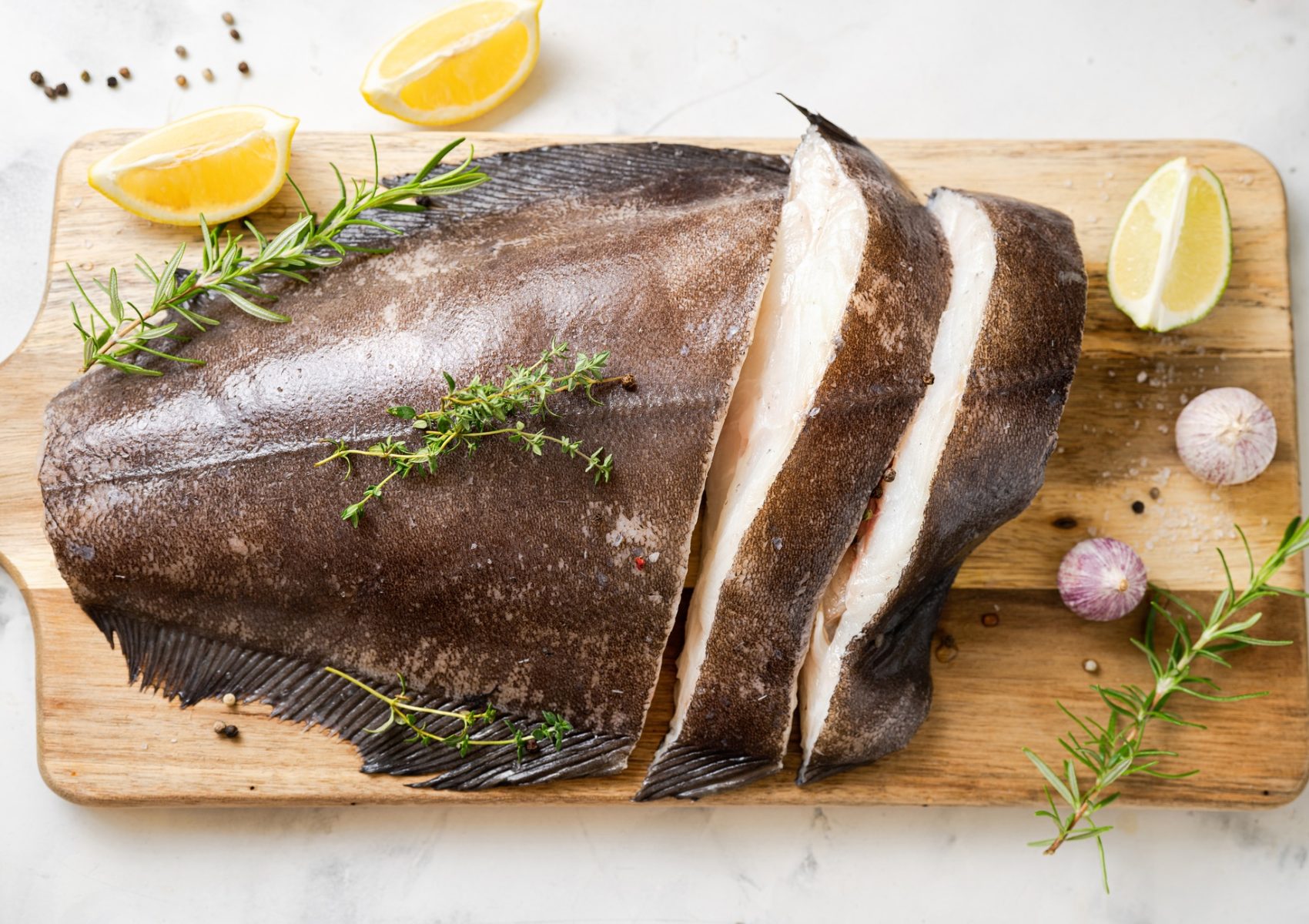 Close up of fresh halibut fish on wodden board